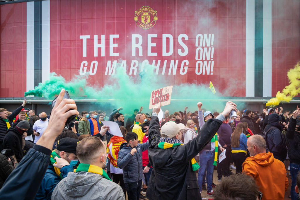 Football fans gather in Old Trafford to protest against the