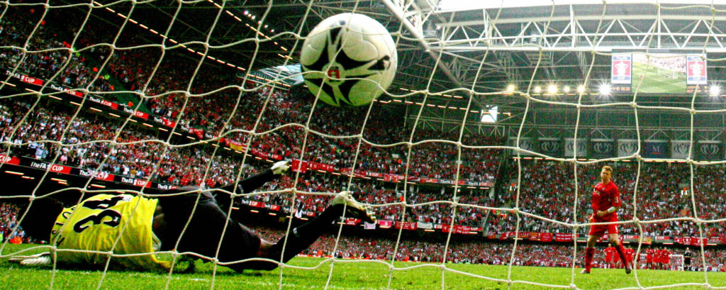 Liverpool's John Arne Riise (R) puts the