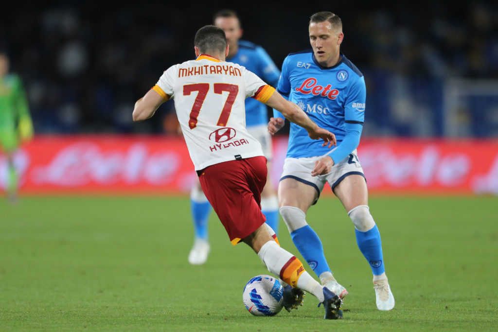 SSC Napoli's Polish midfielder Piotr Zielinski  challenges...