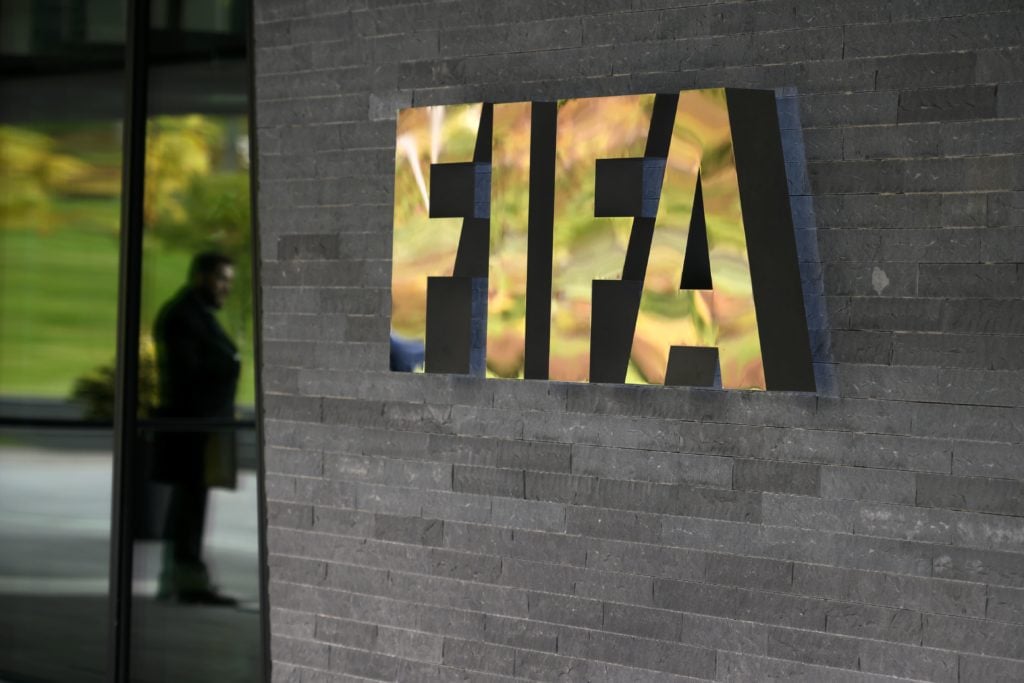 A sign of the FIFA is seen at the entrance of the world football's governing body headquarters on October 13, 2016 in Zurich. / AFP / FABRICE COFFRINI