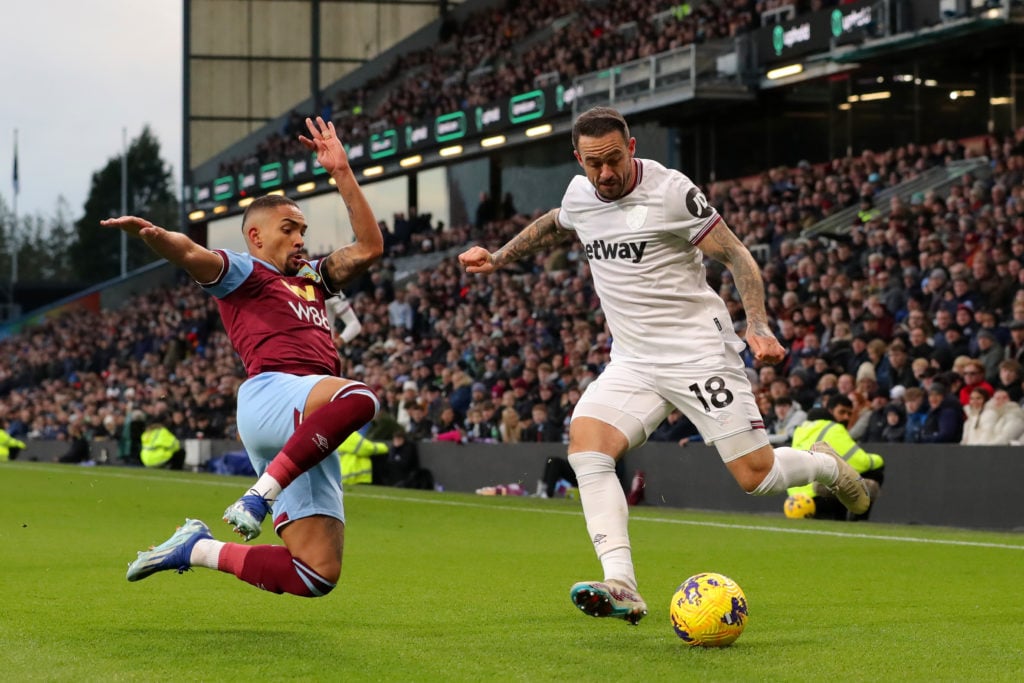 Danny Ings of West Ham United is challenged by Vitinho of Burnley during the Premier League match between Burnley FC and West Ham United at Turf Mo...