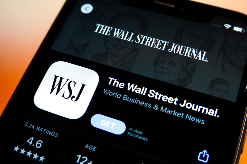 In this photo illustration, the Wall Street Journal logo is