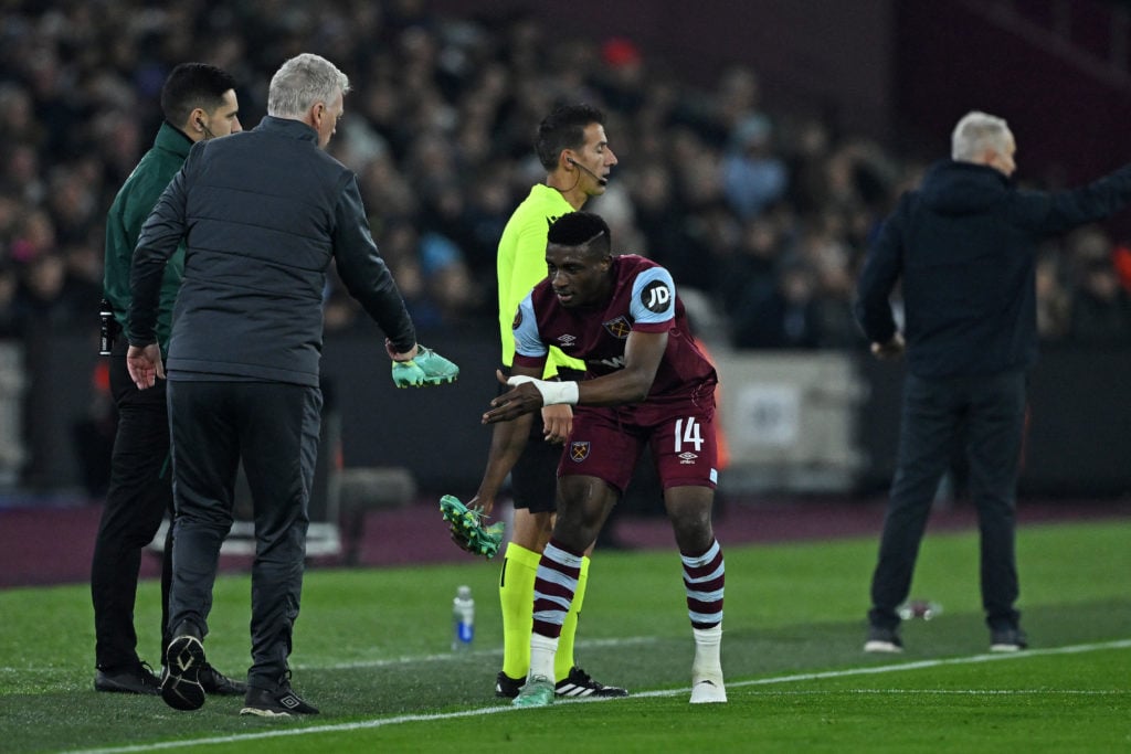 West Ham United's Scottish manager David Moyes passes a new boot for West Ham United's Ghanaian midfielder #14 Mohammed Kudus during the UEFA Europ...
