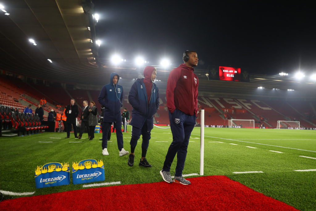 Issa Diop of West Ham United (right) and Grady Diangana of West Ham United  (center) looks around the pitch with teammates ahead of the Premier Lea...