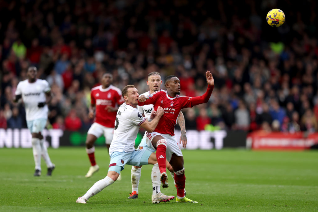 Callum Hudson-Odoi of Nottingham Forest is challenged by Vladimir Coufal and Kalvin Phillips of West Ham United during the Premier League match bet...