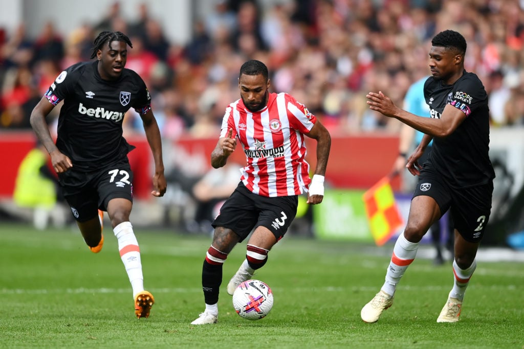 Brentford's Rico Henry runs with the ball under pressure from West Ham United's Divin Mubama and Ben Johnson during the Premier League match...