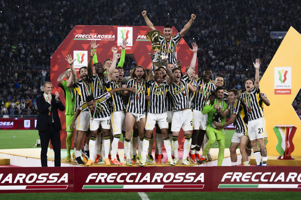 Danilo Luiz da Silva of Juventus FC lifts the trophy as the