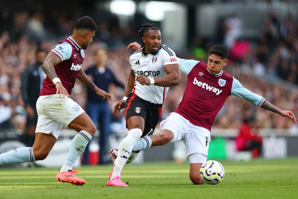 Adama Traore of Fulham is tackled by Edson Alvarez of West Ham United during the Premier League match between Fulham FC and West Ham United FC at C...