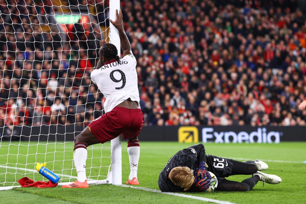 Michail Antonio of West Ham United leaps over Liverpool goalkeeper Caoimhin Kelleher into the post during the Carabao Cup Third Round match between...