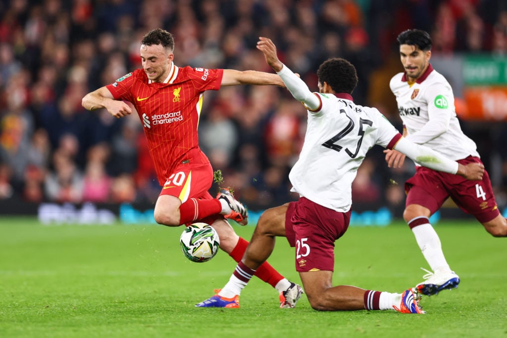 Diogo Jota of Liverpool is tackled by Jean-Clair Todibo of West Ham United during the Carabao Cup Third Round match between Liverpool and West Ham ...