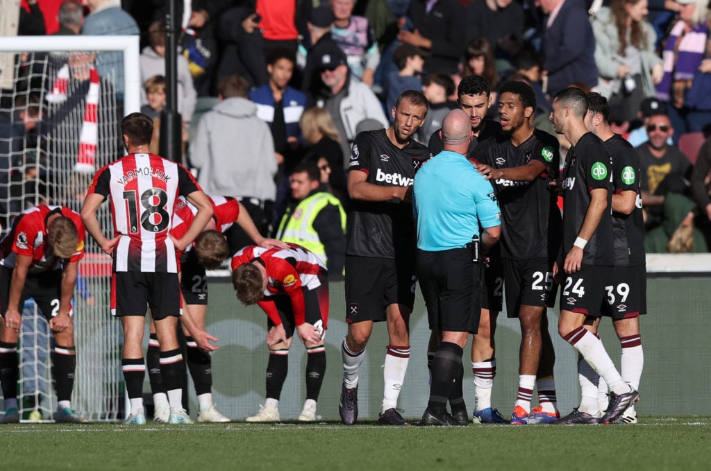 Tomas Soucek, Max Kilman and Jean-Clair Todibo of West Ham United interact with Referee Simon Hooper at full-time following the Premier League matc...