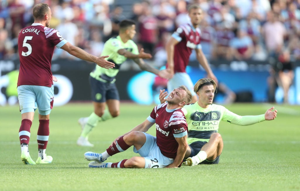 West Ham United's Jarrod Bowen is in pain after a challenge from Manchester City's Jack Grealish during the Premier League match between West Ham U...