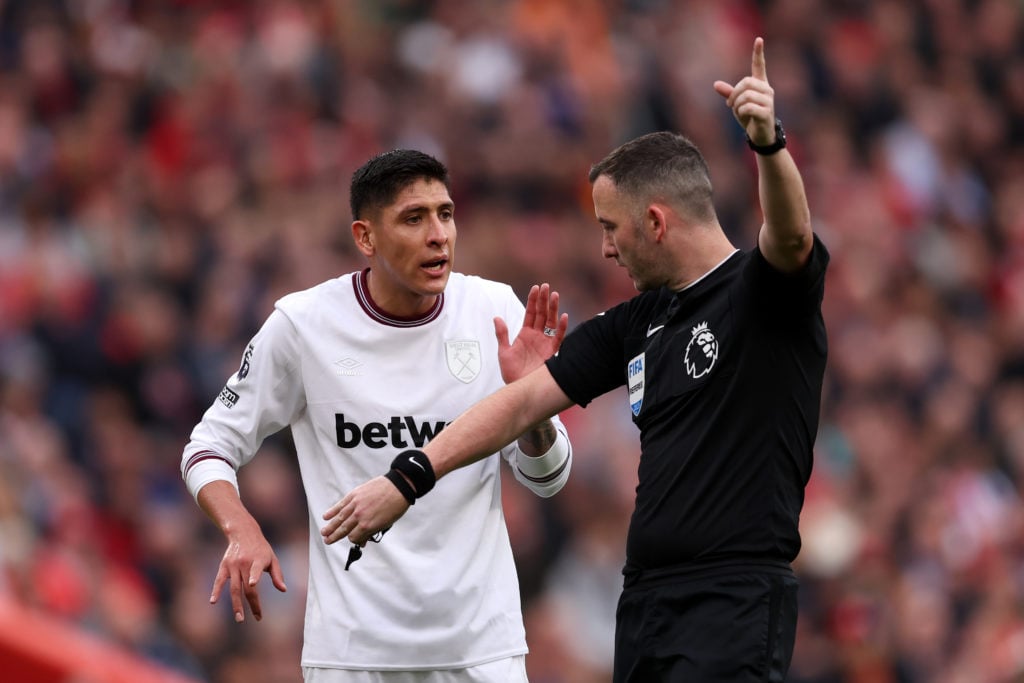 Referee Chris Kavanagh speaks to Edson Alvarez of West Ham United during the Premier League match between Liverpool FC and West Ham United at Anfie...