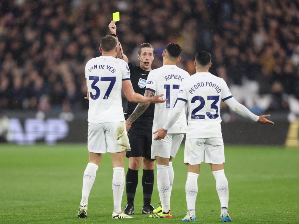 Tottenham Hotspur's Micky van de Ven receives a yellow card from referee John Brooks during the Premier League match between West Ham United and To...