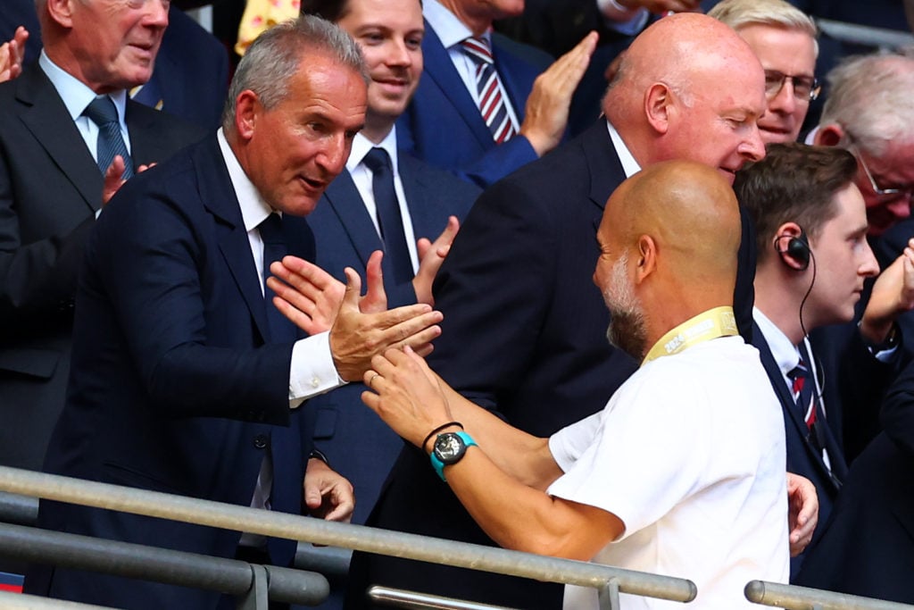 Manchester City manager Josep Guardiola shakes hands with director of football Aitor 