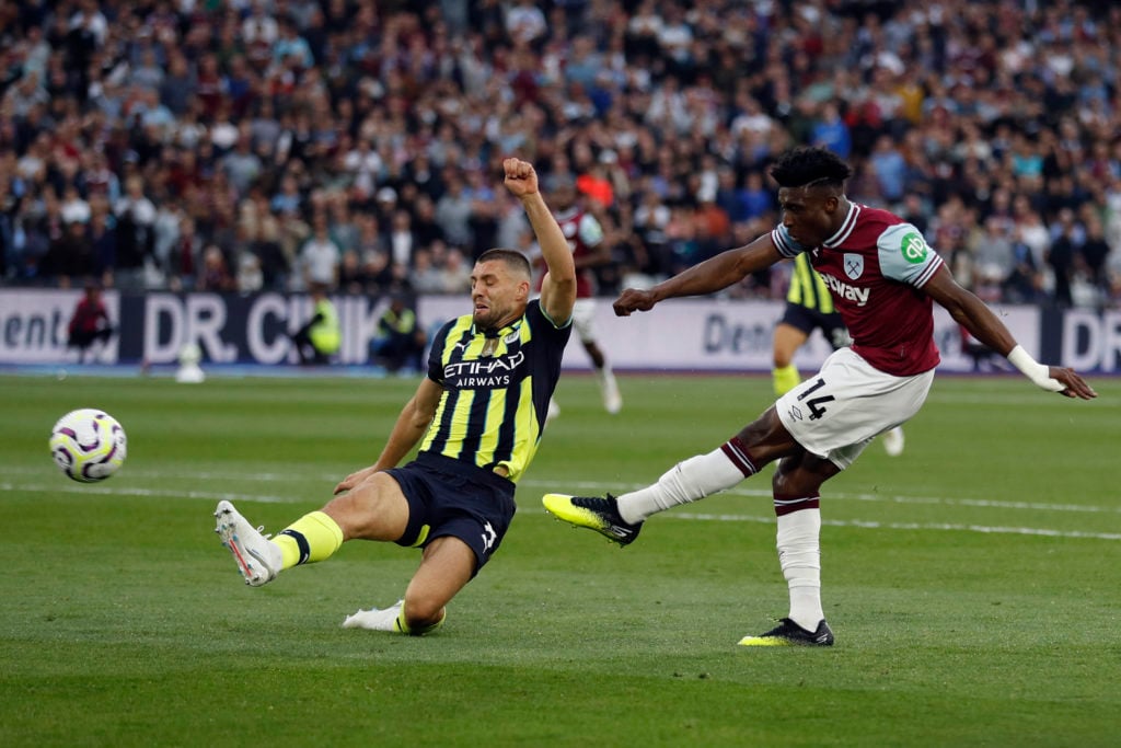 Manchester City's Croatian midfielder #08 Mateo Kovacic challenges West Ham United's Ghanaian midfielder #14 Mohammed Kudus during the English Prem...