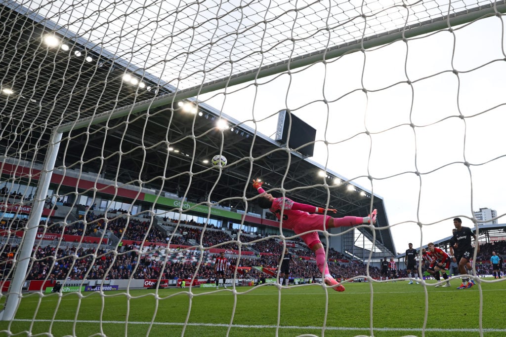 West Ham United's French goalkeeper #23 Alphonse Areola dives but concedes the opening goal by Brentford's French-born Cameroonian striker #19 Brya...