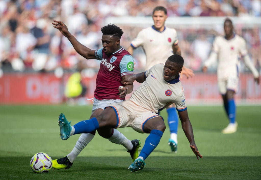 Mohammed Kudus of West Ham United (L) is fouled by Moises Caicedo of Chelsea (R) during the Premier League match between West Ham United FC and Che...