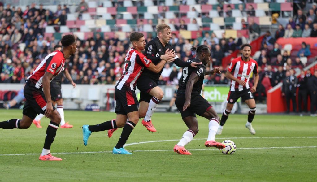 West Ham United's Jarrod Bowen and Michail Antonio hold off Brentford's Vitaly Janelt during the Premier League match between Brentford FC and West...