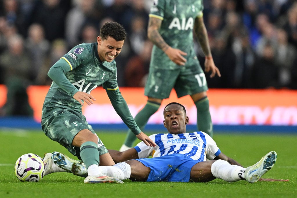 Brennan Johnson of Tottenham Hotspur is tackled by Pervis Estupinan of Brighton & Hove Albion during the Premier League match between Brighton ...