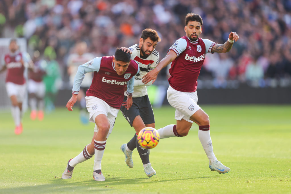 Bruno Fernandes of Manchester United battles for possession with Lucas Paqueta and Edson Alvarez of West Ham United  during the Premier League matc...