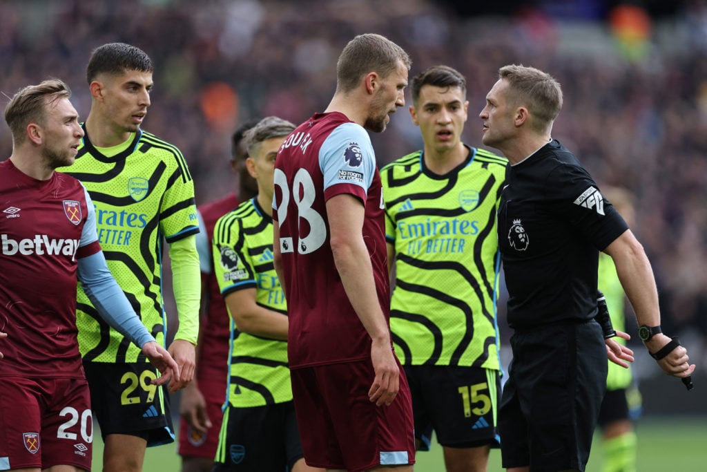 English referee Craig Pawson (R) speaks with West Ham United's Czech midfielder #28 Tomas Soucek (C) during the English Premier League football mat...