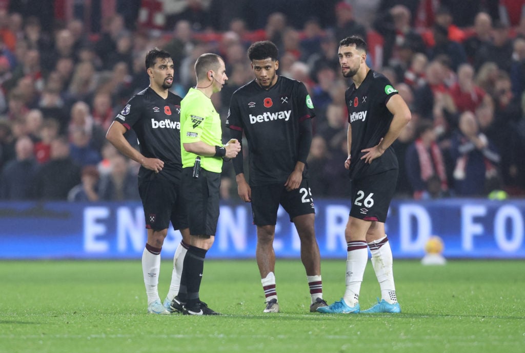 West Ham United's Lucas Paqueta, Jean-Clair Todibo and Max Kilman in discussion with referee Peter Bankes during the Premier League match between N...