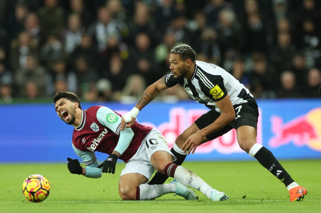 Lucas Paqueta of West Ham United (L) reacts after a tackle from Joelinton of Newcastle United during the Premier League match between Newcastle Uni...