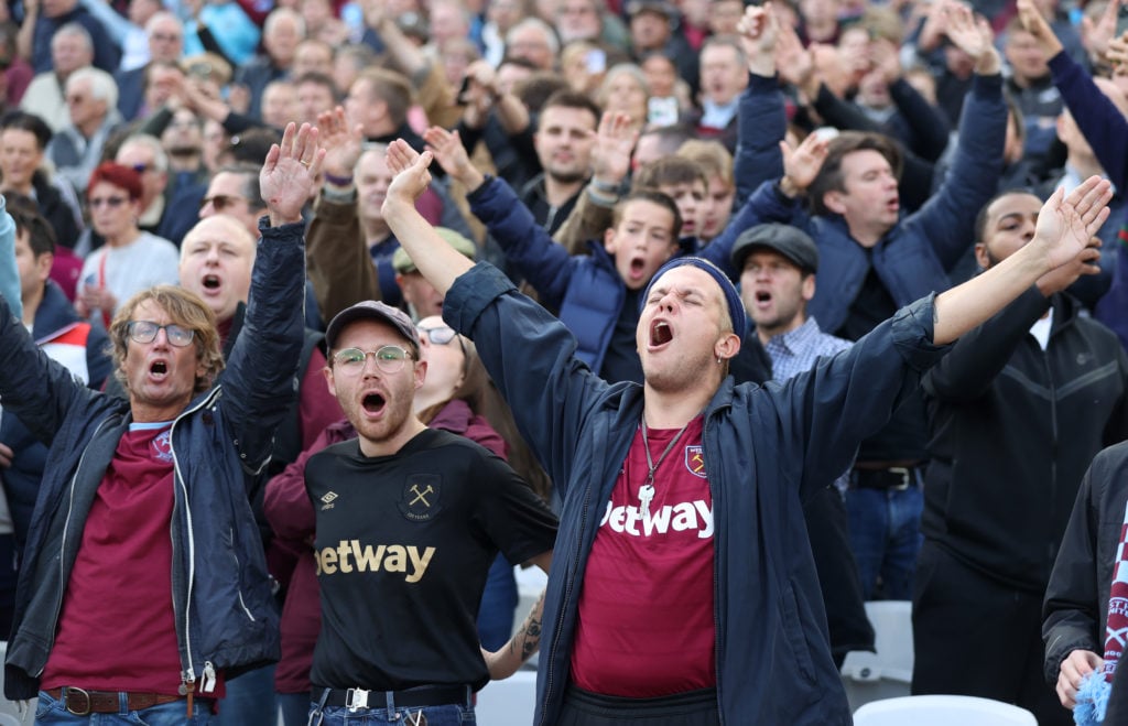 West Ham United fans show their support inside the stadium during the Premier League match between West Ham United and Tottenham Hotspur at London ...