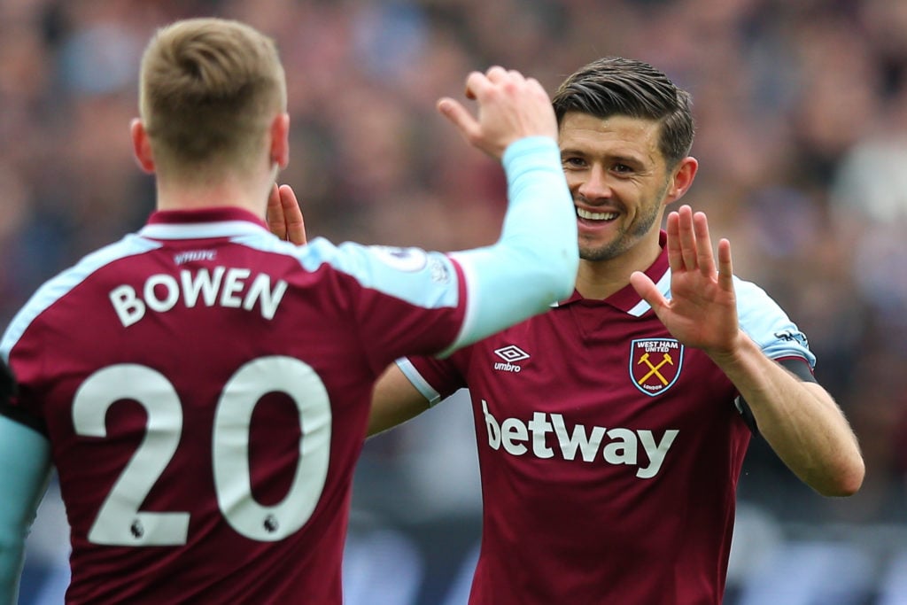 Aaron Cresswell of West Ham United celebrates with team mate Jarrod Bowen after scoring the opening goal during the Premier League match between We...