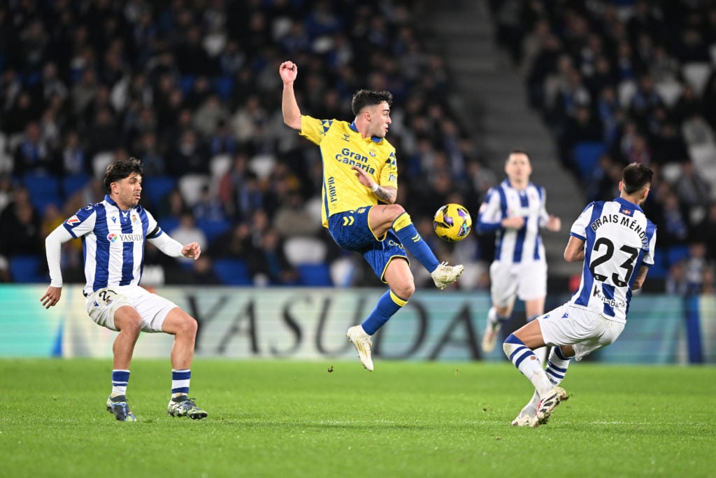 (L-R) Jon Aramburu of Real Sociedad, Alberto Moleiro of Las Palmas, Brais Mendez of Real Sociedad  during the LaLiga EA Sports  match between Real ...