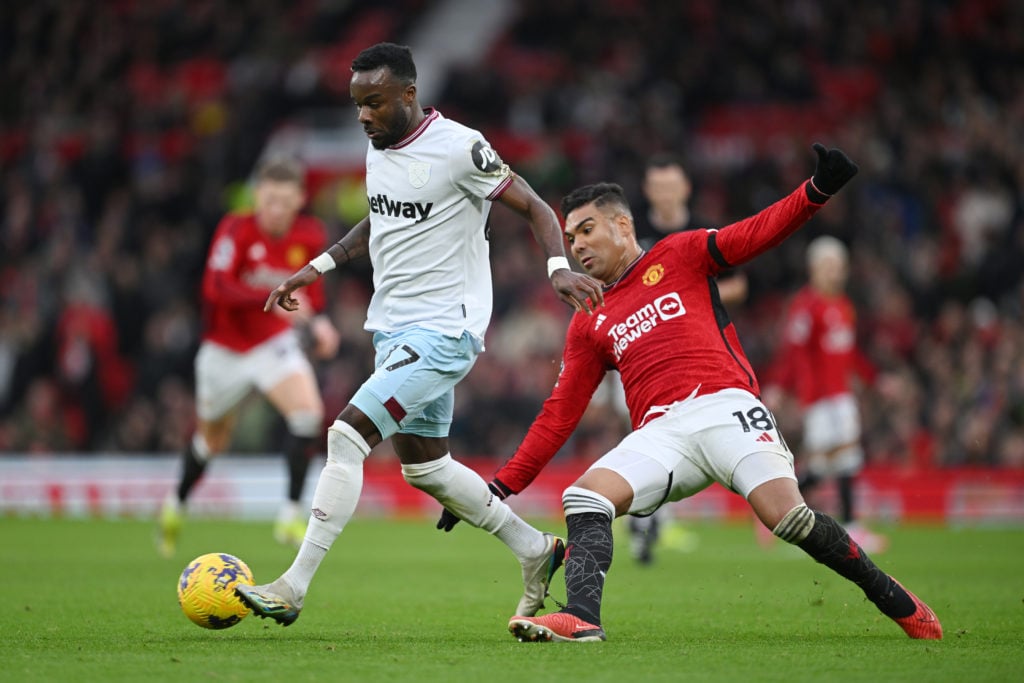 Maxwel Cornet of West Ham in action with Casemiro of Manchester United during the Premier League match between Manchester United and West Ham Unite...