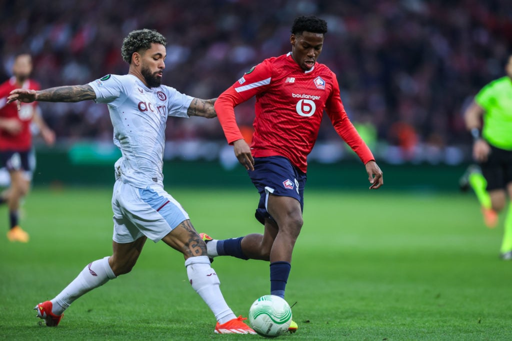 Douglas Luiz of Aston Villa FC (left) is competing against Jonathan David of LOSC Lille (right) during the UEFA Europa Conference League quarter-fi...