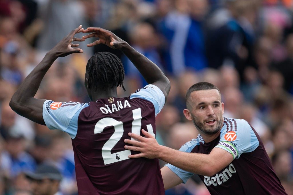 Amadou Onana of Aston Villa celebrates scoring his team's first goal with team mate John McGinn during the Premier League match between Leicester C...