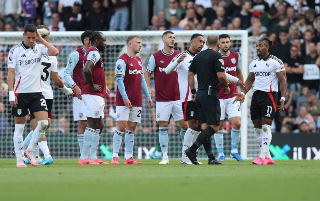 West Ham United's Jarrod Bowen and Fulham's Kenny Tete in discussion with referee Tim Robinson during the Premier League match between Fulham FC an...