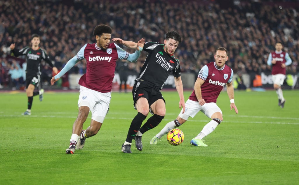 Arsenal's Declan Rice holds off West Ham United's Jean-Clair Todibo and Vladimir Coufal during the Premier League match between West Ham United FC ...