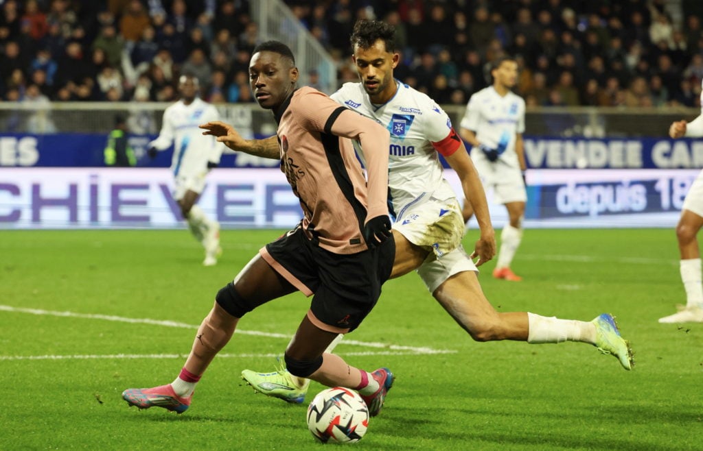 Randal Kolo Muani #23 of Paris Saint-Germain in action with captain, Jubal Jr #4 of Auxerre during the Ligue 1 match between AJ Auxerre and Paris S...