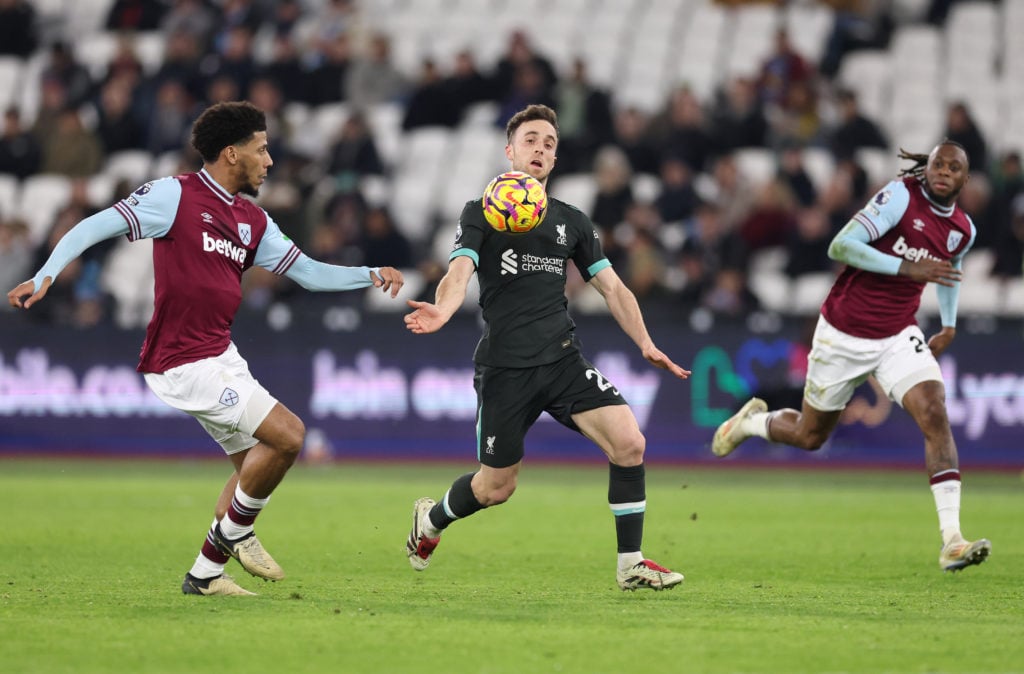 Diogo Jota of Liverpool battles for possession with Jean-Clair Todibo of West Ham United during the Premier League match between West Ham United FC...