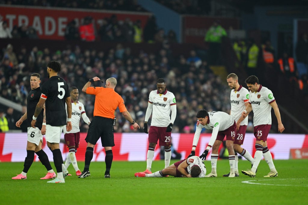 Niclas Fuellkrug of West Ham United goes down with an injury as his teammates react during the Emirates FA Cup Third Round match between Aston Vill...