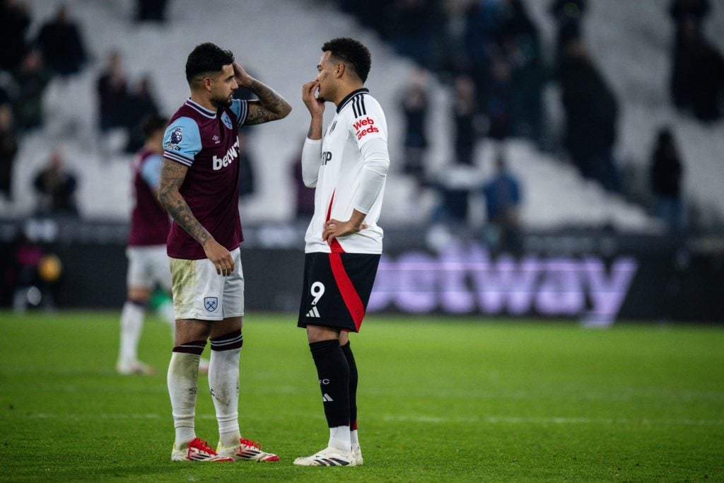 Emerson Palmieri of West Ham United and Rodrigo Muniz of Fulham during the Premier League match between West Ham United FC and Fulham FC at London ...