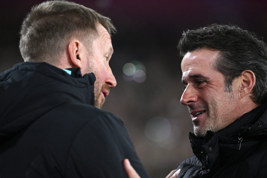 Graham Potter, Head Coach of West Ham United, interacts with Marco Silva, Manager of Fulham, prior to the Premier League match between West Ham Uni...