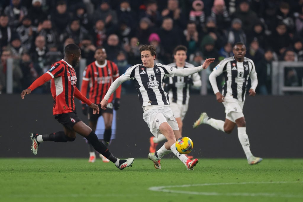 Kenan Yildiz of Juventus passes the ball as Fikayo Tomori of AC Milan closes in during the Serie A match between Juventus FC and AC Milan at Allian...