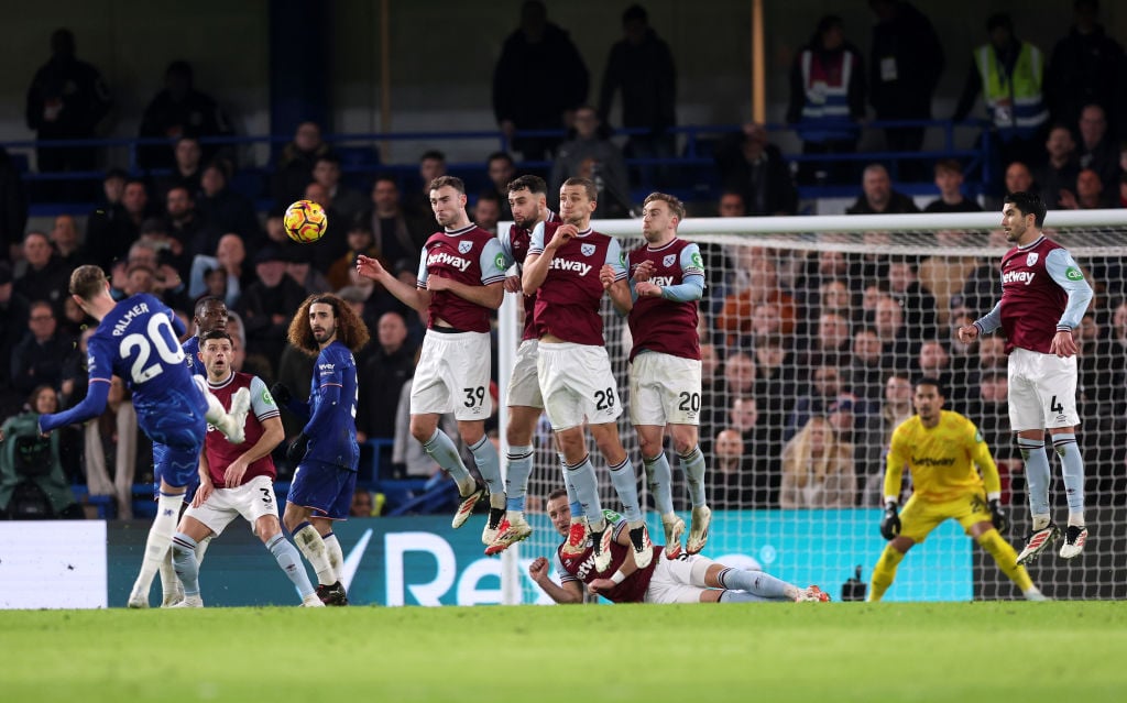 Cole Palmer from Chelsea (darkened) takes a free kick like Andy Irving, Max Kilman, Tomasz Sucek and Jarrd Bowen of West Ham United Jump to Protect Dur ...