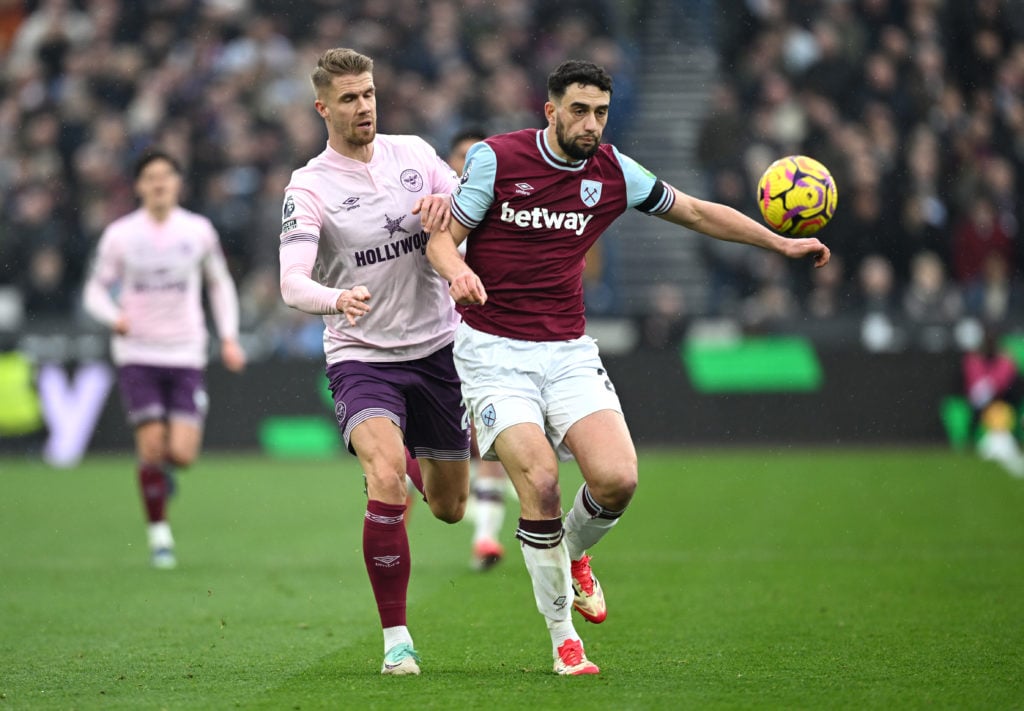 Max Kilman of West Ham United is put under pressure by Kristoffer Ajer of Brentford during the Premier League match between West Ham United FC and ...