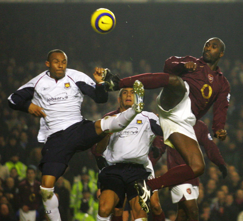 Arsenal's Sol Cambell (R) vies for the b