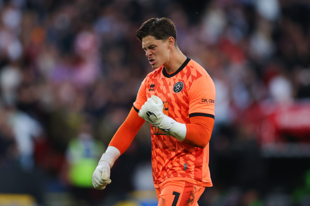 Sheffield United goalkeeper Michael Cooper pumps his fist in celebration