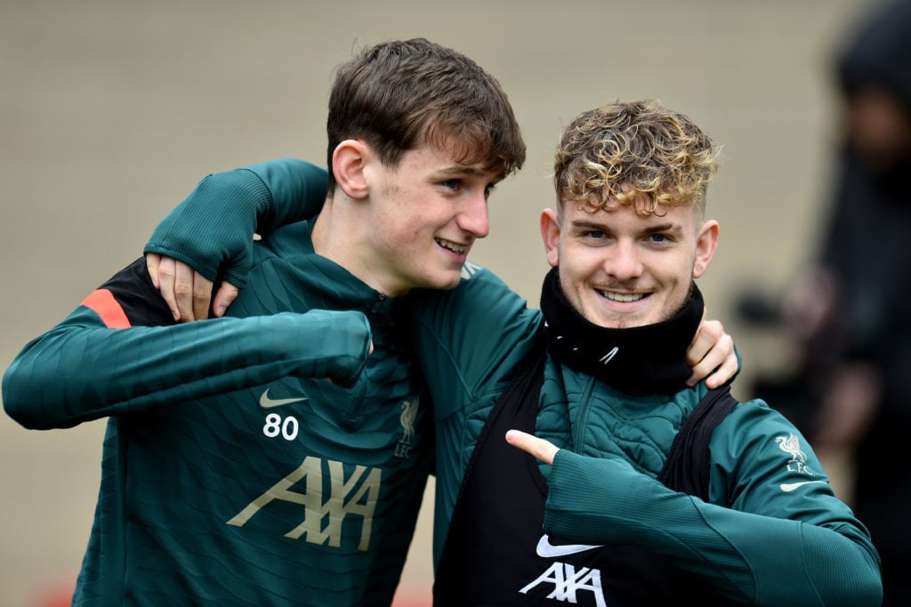 Tyler Morton and Harvey Elliott embrace during a Liverpool training session