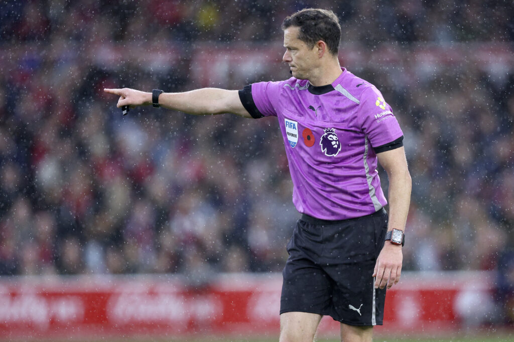 Referee Darren England pointing during a Premier League match