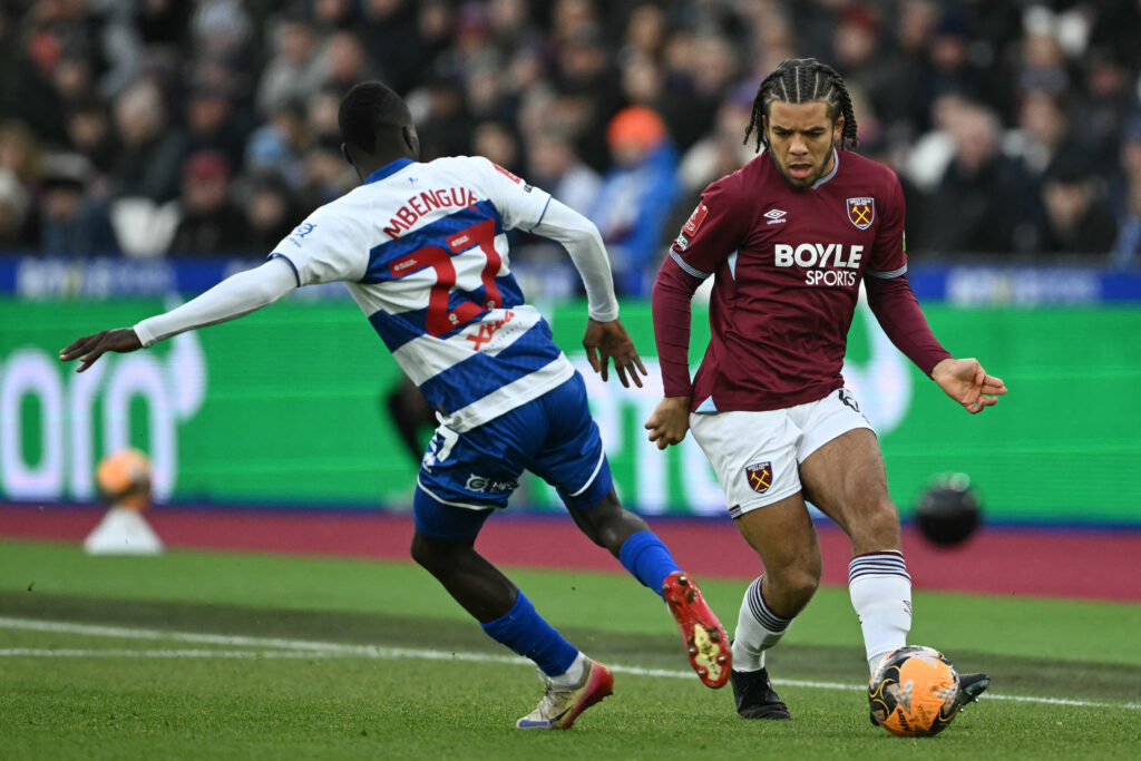 West Ham's Ezra Mayers runs past QPR defender Amadou Mbengue during their FA Cup third round clash.