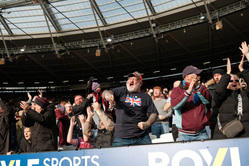 West Ham fans celebrate their team's goal against Sunderland in a Premier League match.